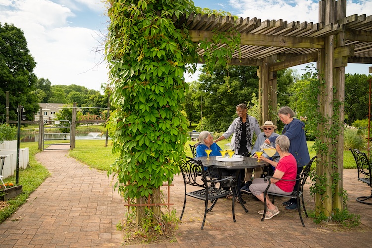 Residents gathered around a table outside